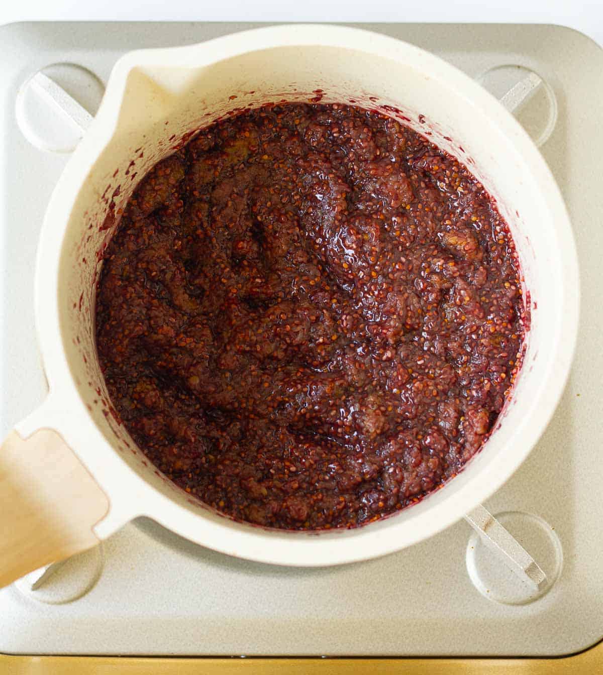 Cooked mulberry chia seed jam in a saucepan.