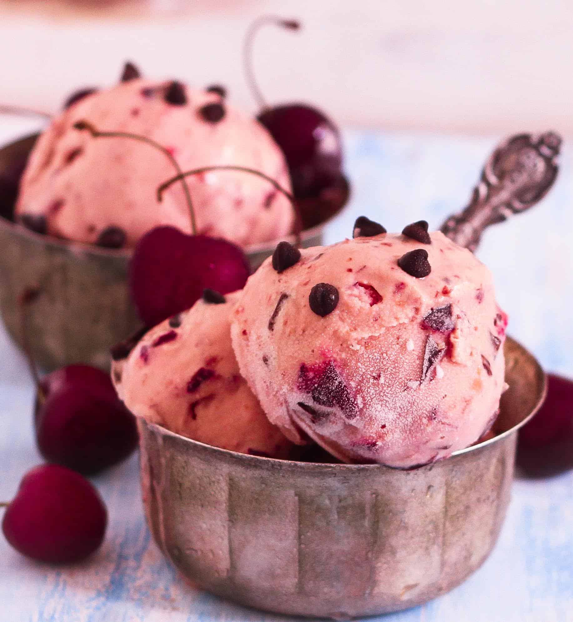 cherry frozen yogurt scoops in 2 bowls.