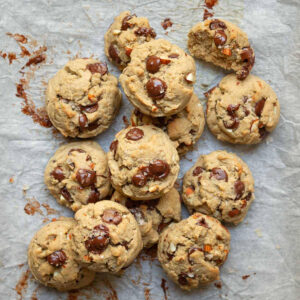 Chocolate chip cookies on parchment paper.