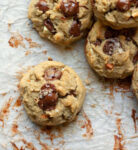 Chocolate chip cookie on parchment paper.