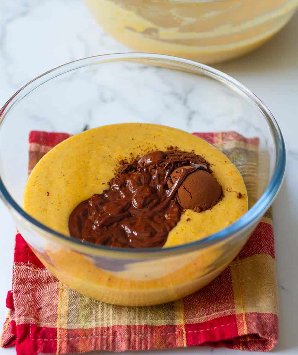 mixing in chocolate and cocoa powder in half of the pumpkin batter
