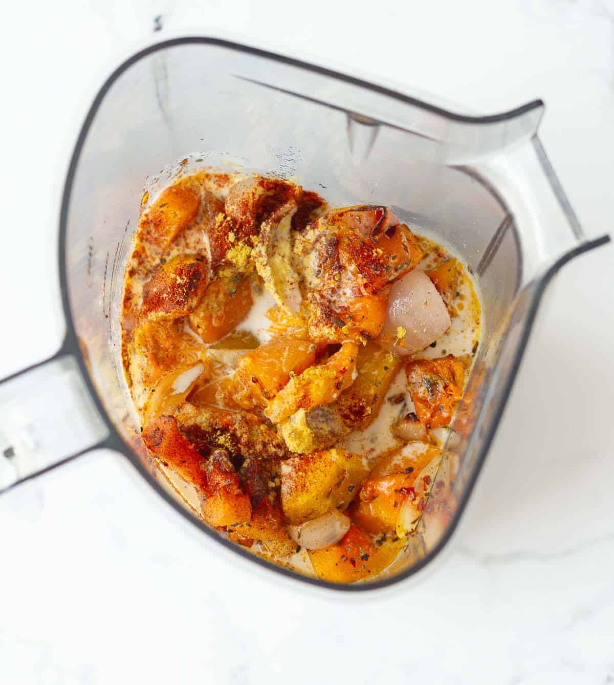 Pumpkin, onion, garlic, coconut milk in a blender jar.