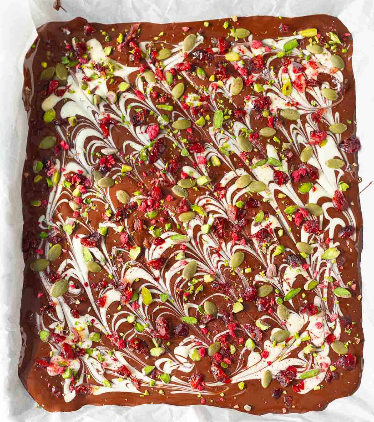 melted chocolates topped with pumpkin seeds, pistachios, cranberries, and freeze-dried raspberries.