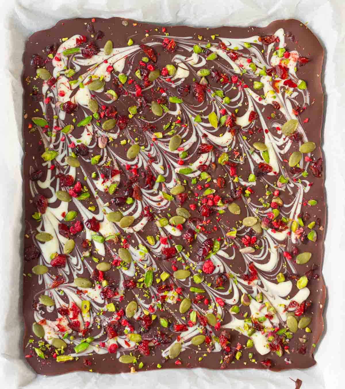dark chocolate bark on parchment-lined tray.