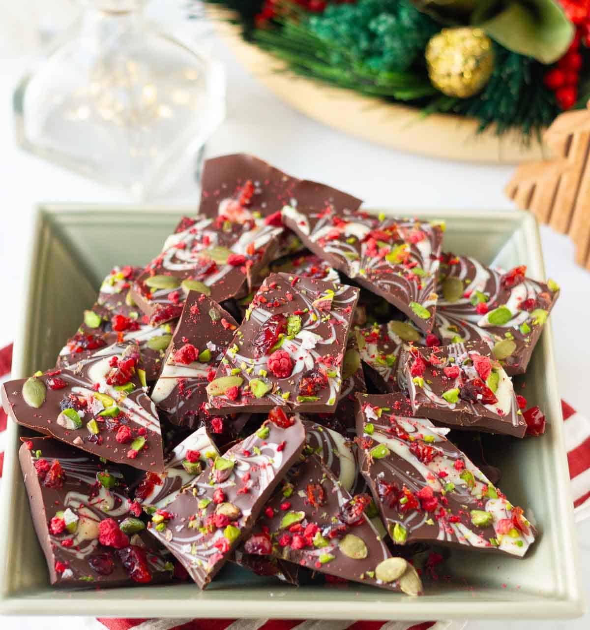 dark chocolate bark pieces in a green bowl.