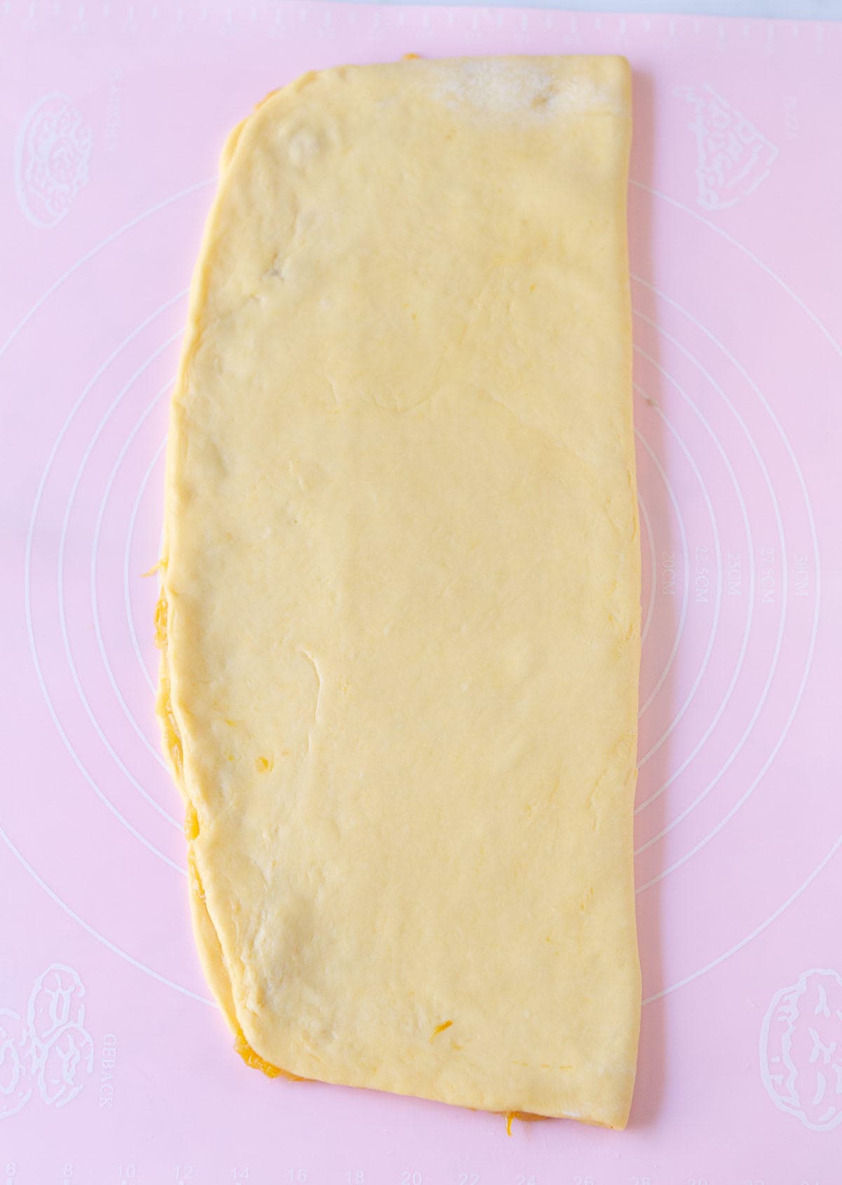 Rolled out dough folded in half.
