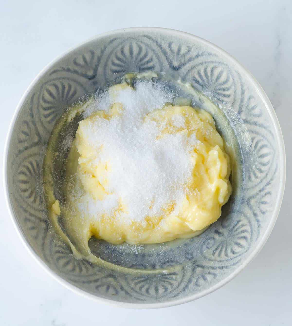 butter and sugar in a blue bowl.