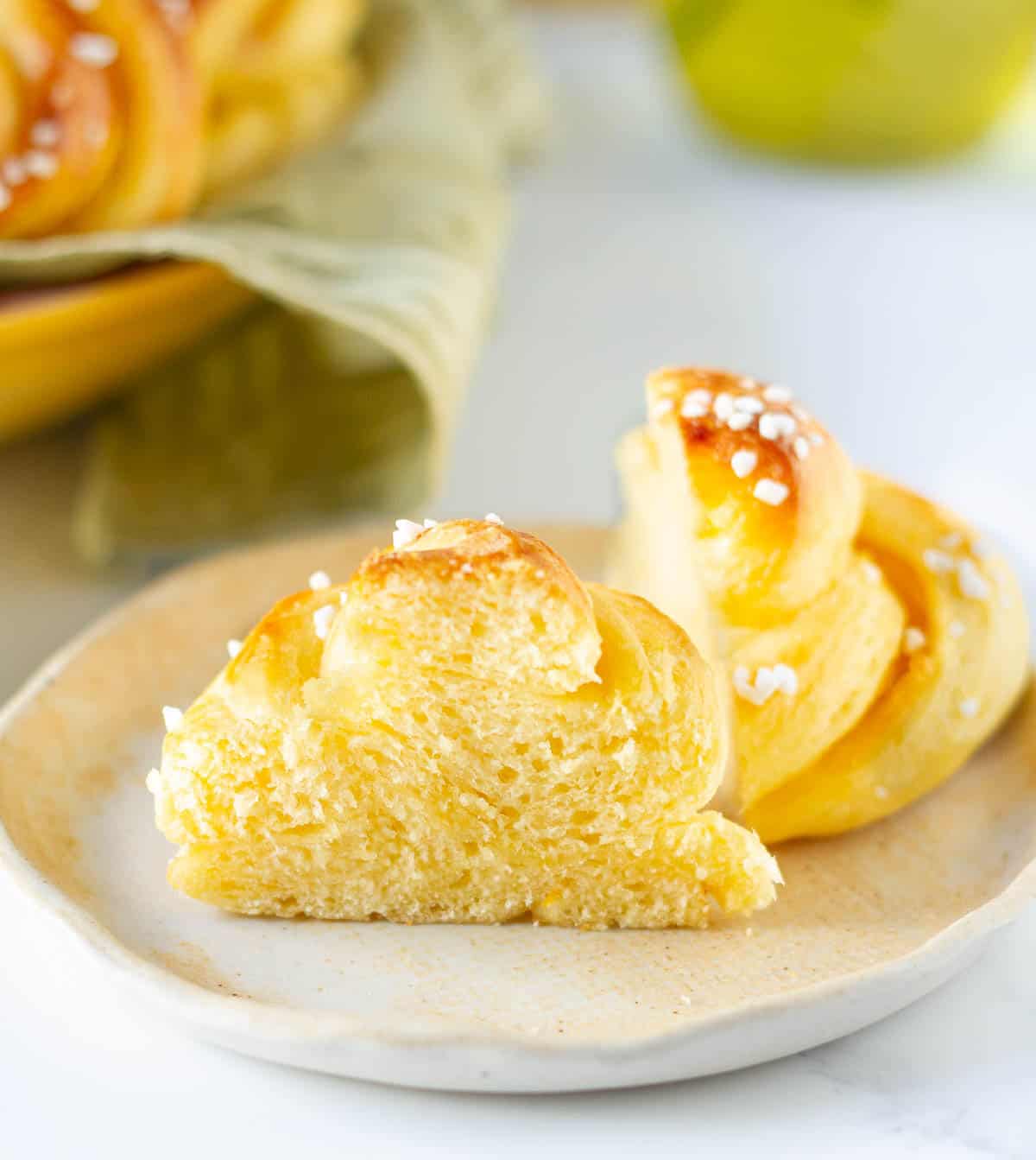 A brioche bun cut in half to show the fluffy texture.