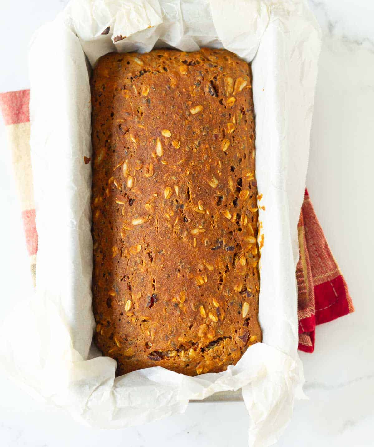 baked batter in a parchment-lined loaf pan.