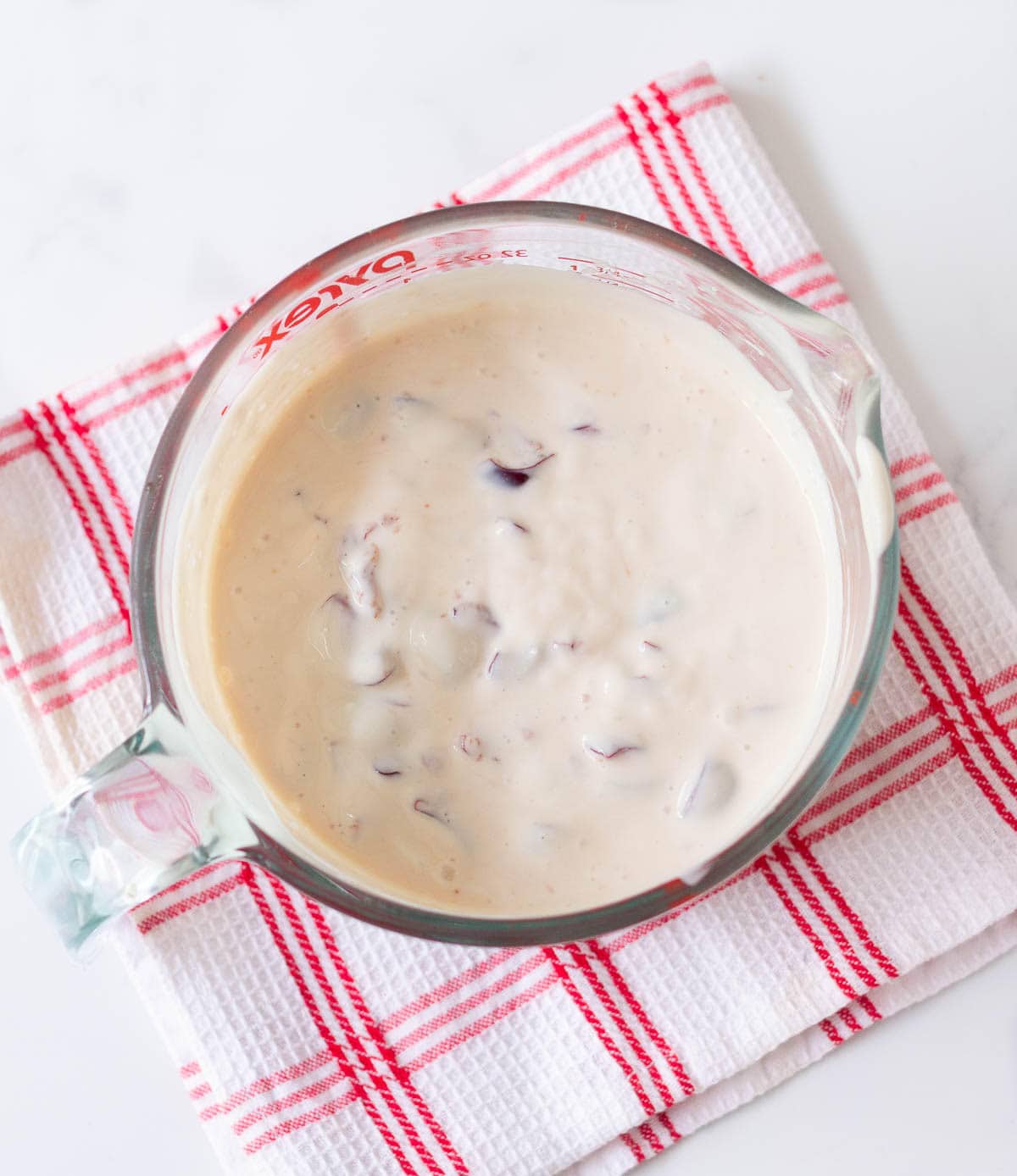 Yogurt cherry mixture in a measuring cup.