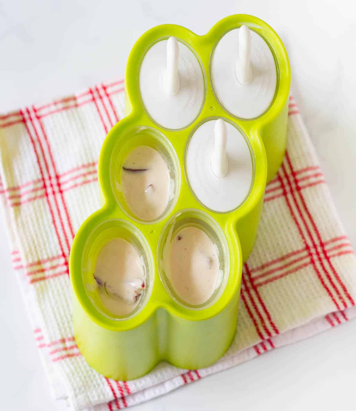 Yogurt cherry mixture in popsicle molds.