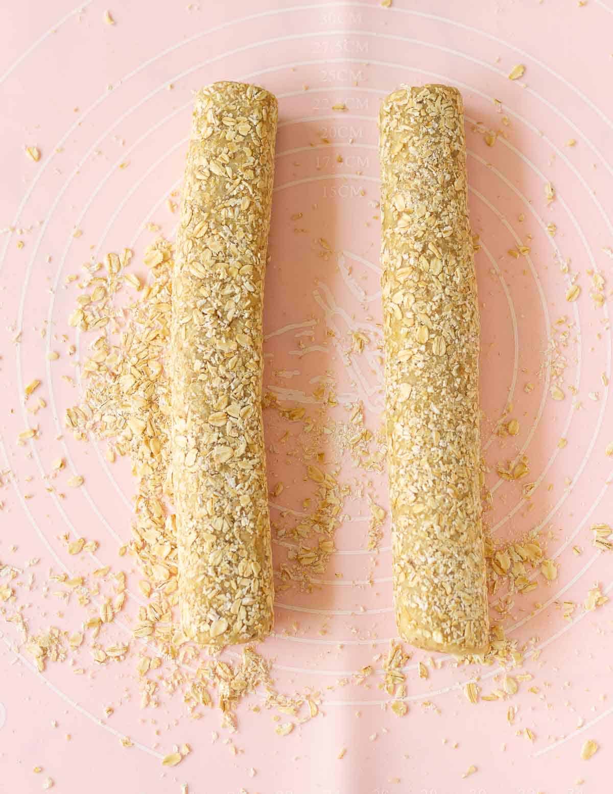 2 dough logs coated with oats.