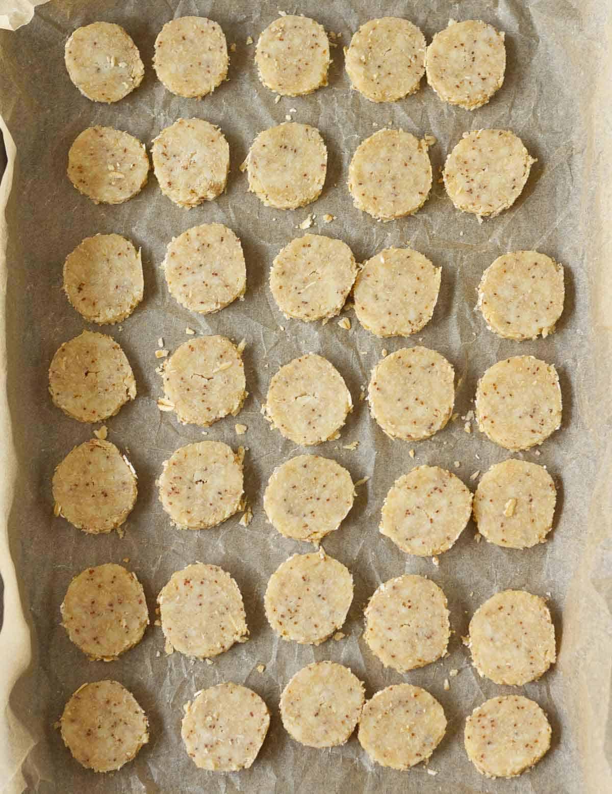 Sliced dough pieces on parchment-lined tray.