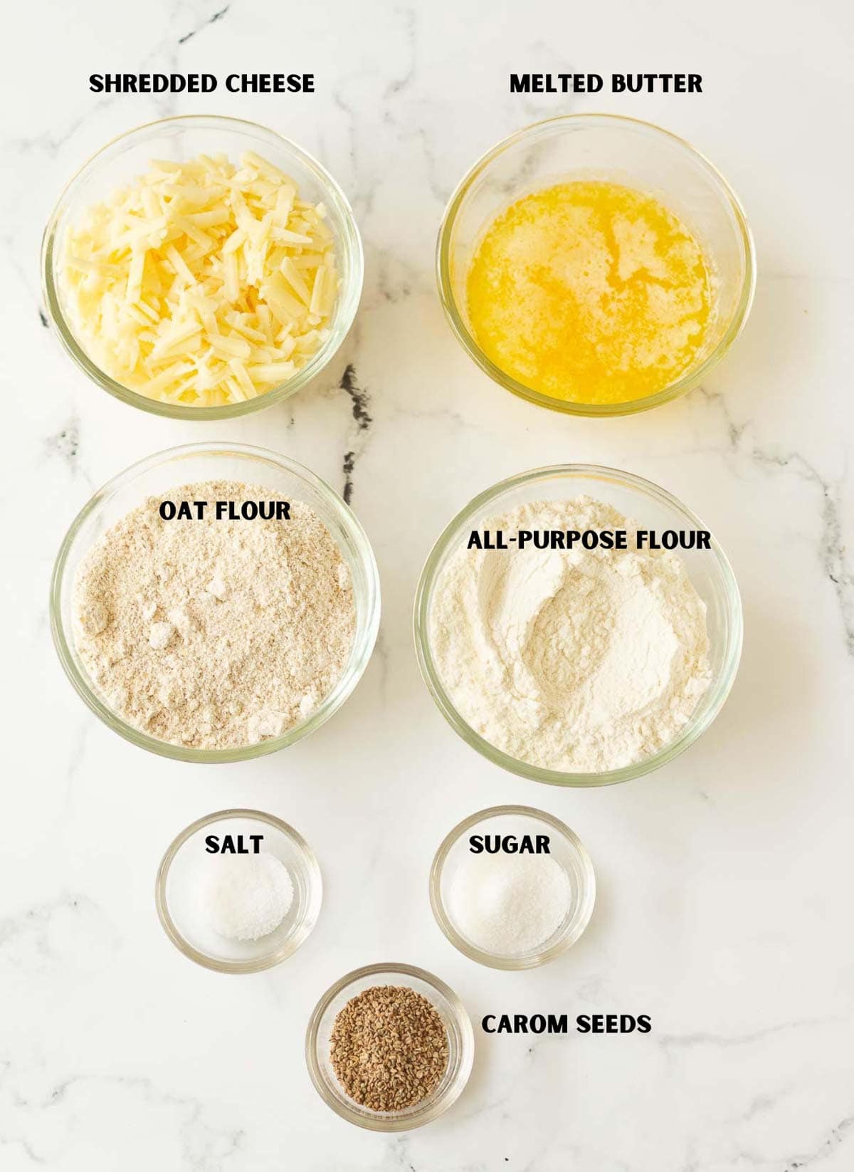 Labelled ingredients for making cheese crackers with carom seeds.