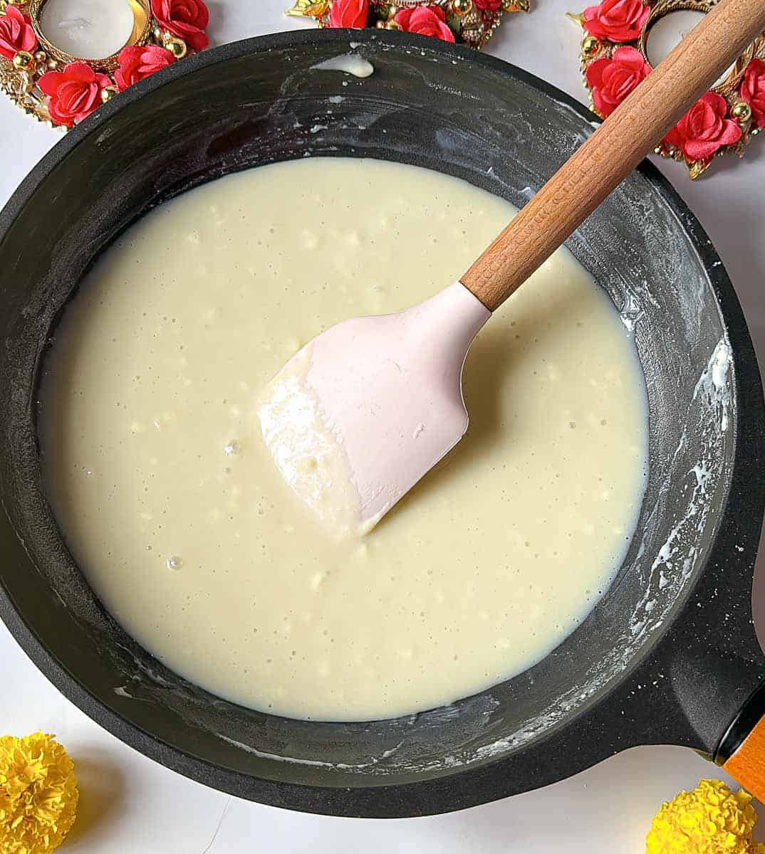 Cooking the mixture of ghee, sugar, milk and milk powder