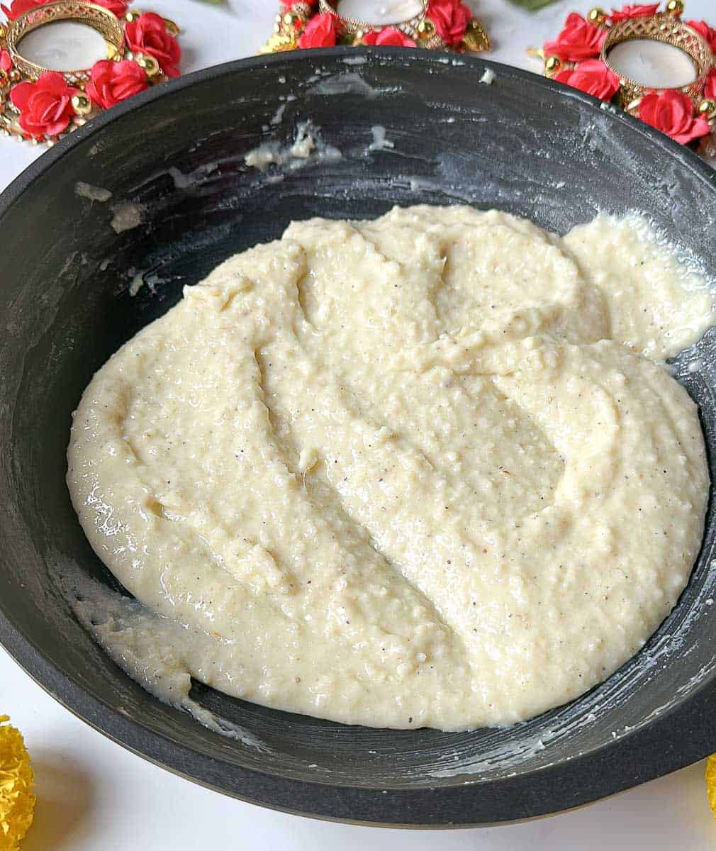 Add desiccated coconut and cardamom powder to the mixture