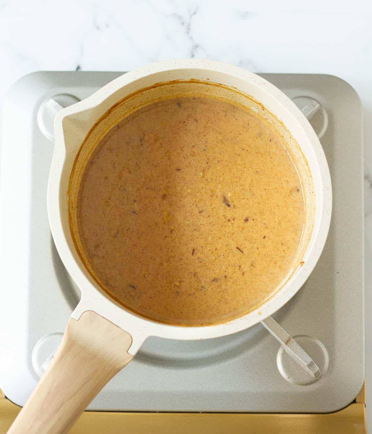 cooked oatmeal in a saucepan on a stove.