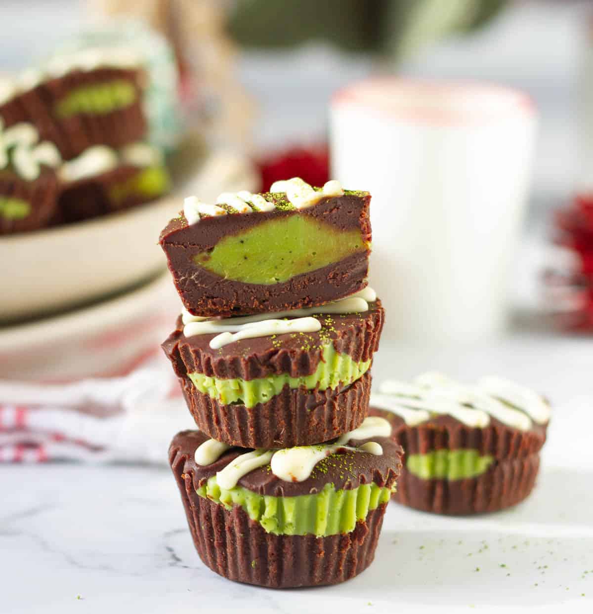 3 chocolate matcha cups stacked with one cut in half.