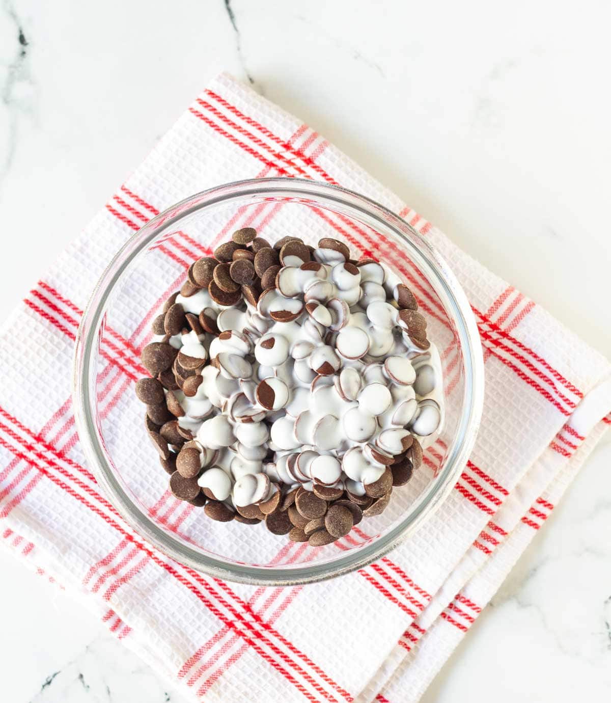 chocolate chips and cream in a mixing bowl.