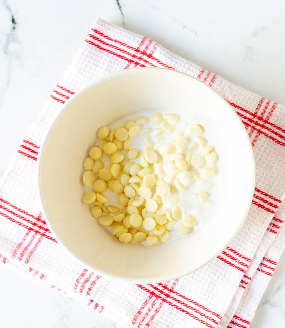 white chocolate and cream in a mixing bowl.