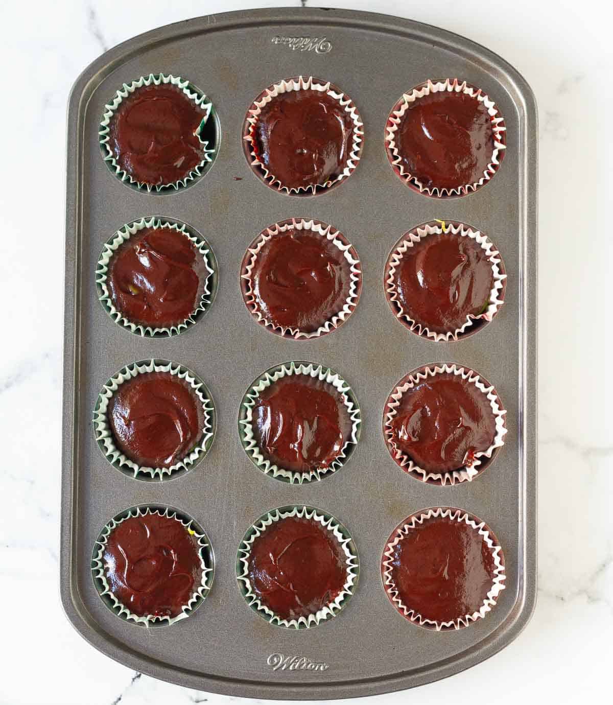 Chocolate covered cups in a mini muffin tray.