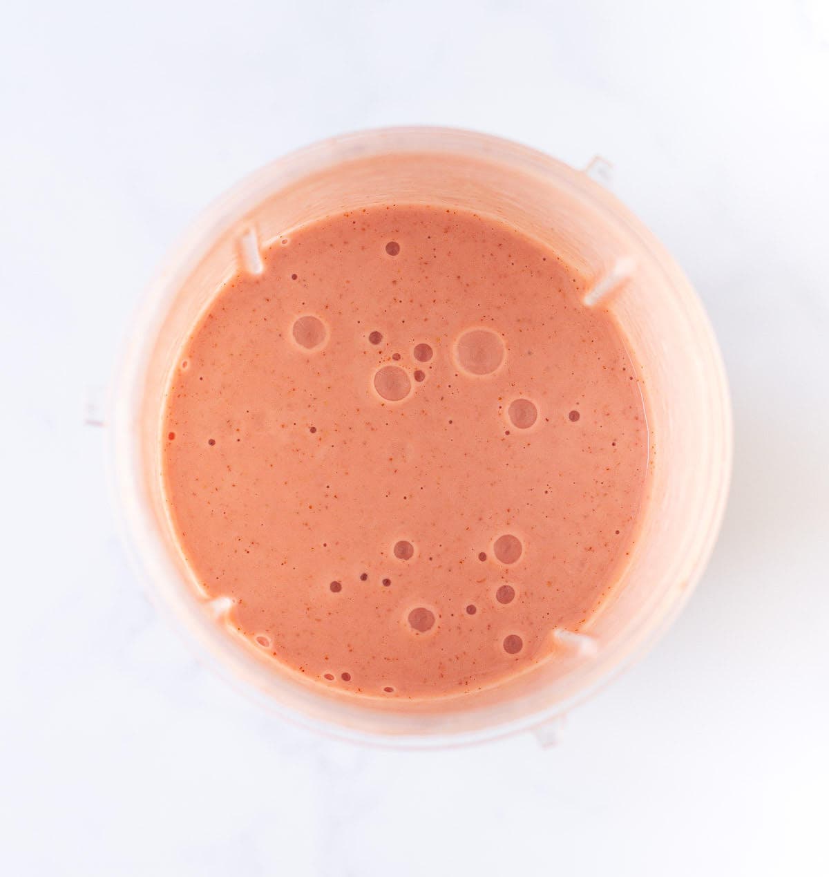 Blended fruits in a blender jar.