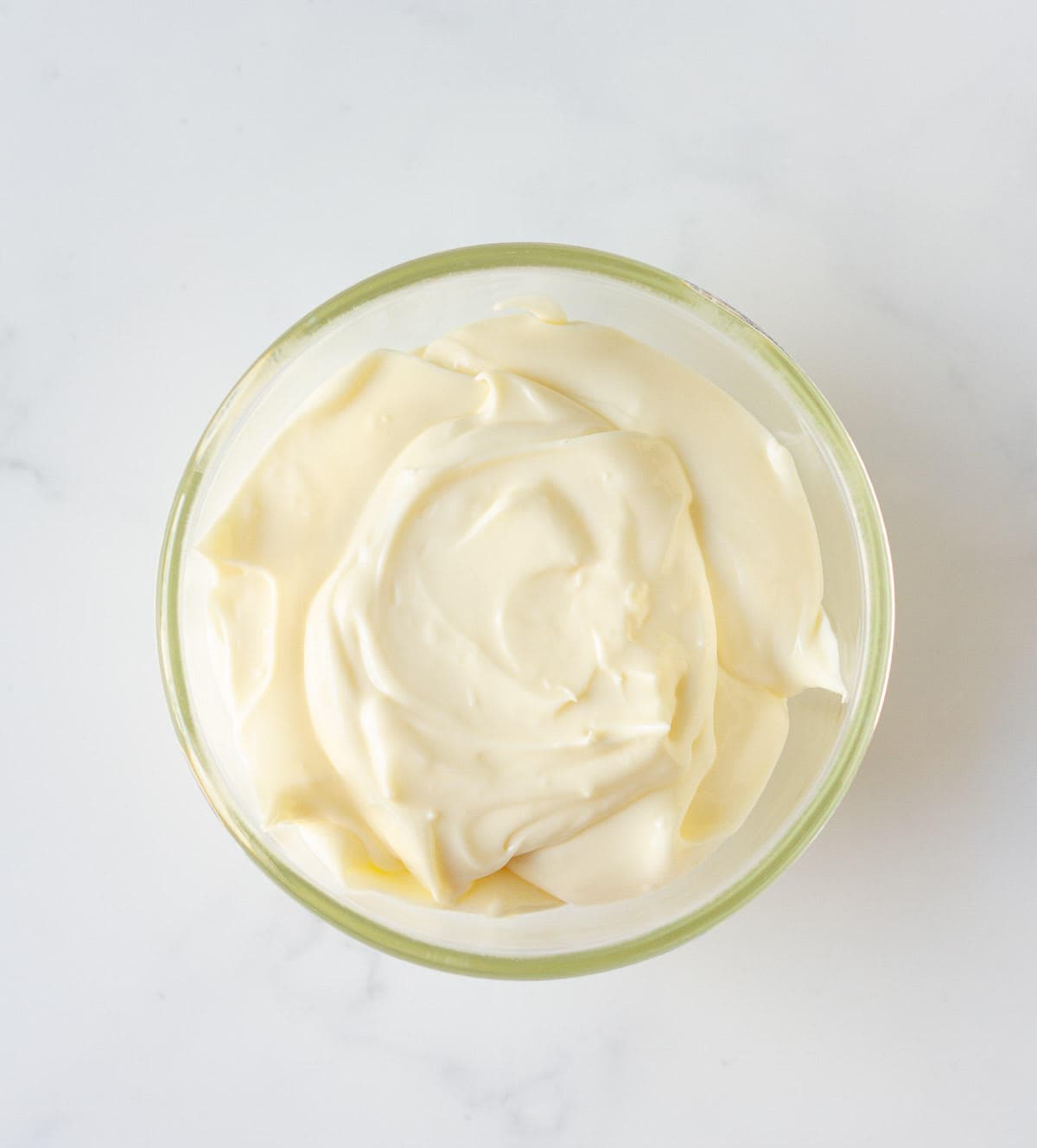 Cream cheese frosting in a small bowl.