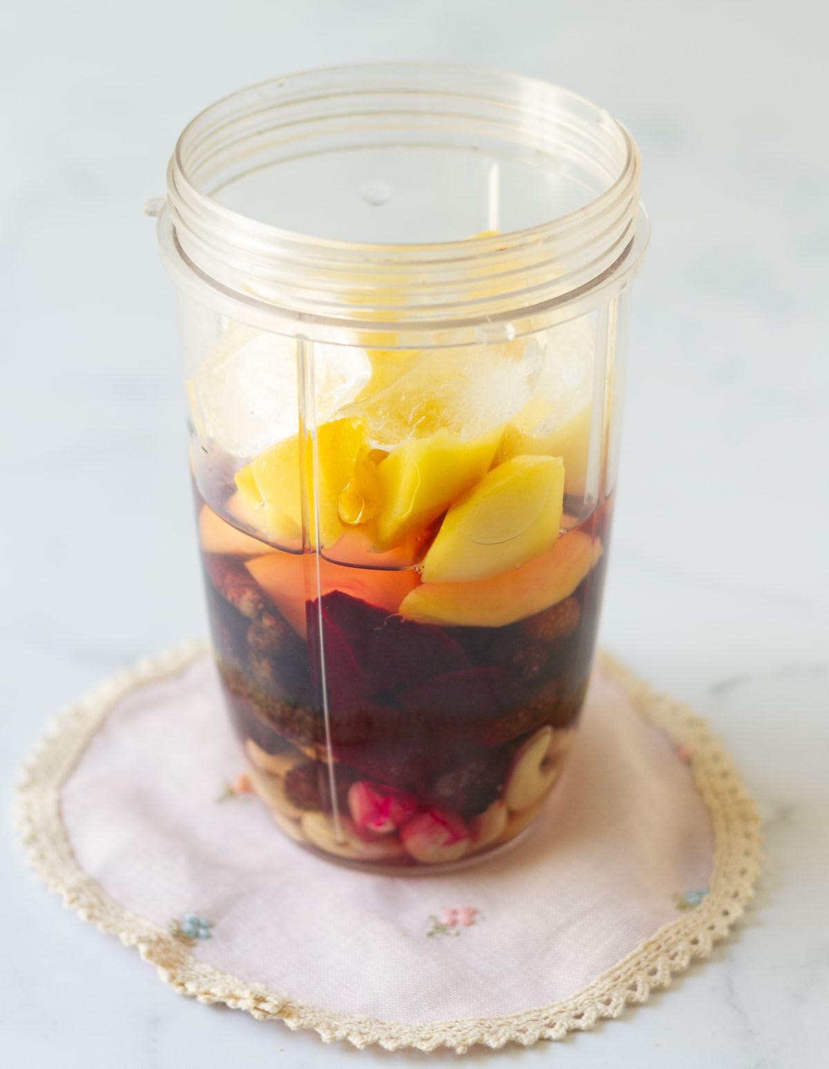 Ingredients for making smoothie in a blender jar.