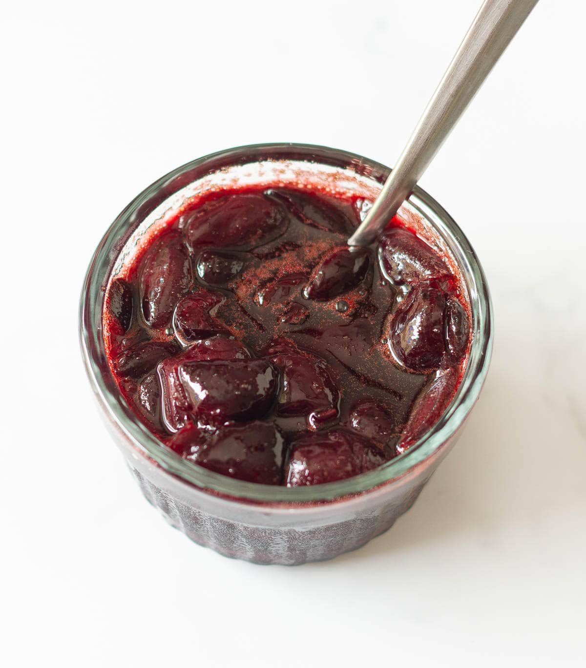 cherry sauce in a small bowl with a spoon.