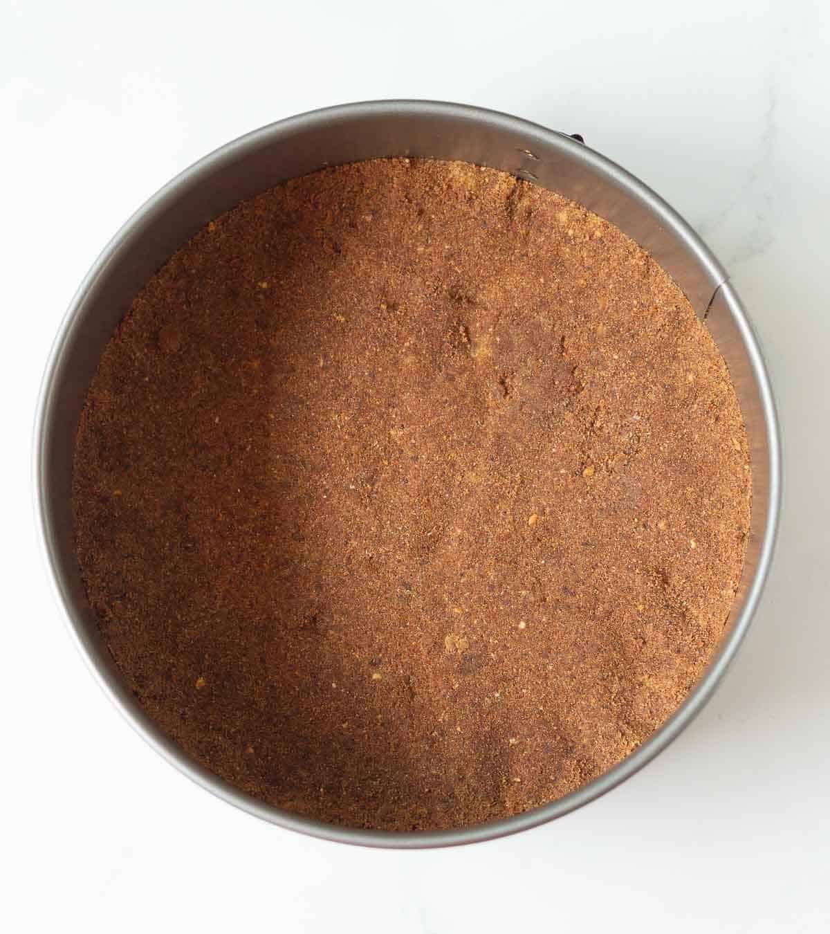 Cookie crust in a cake pan.