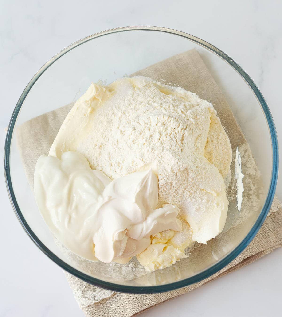 Cream cheese, cream, flour, sugar in a mixing bowl.