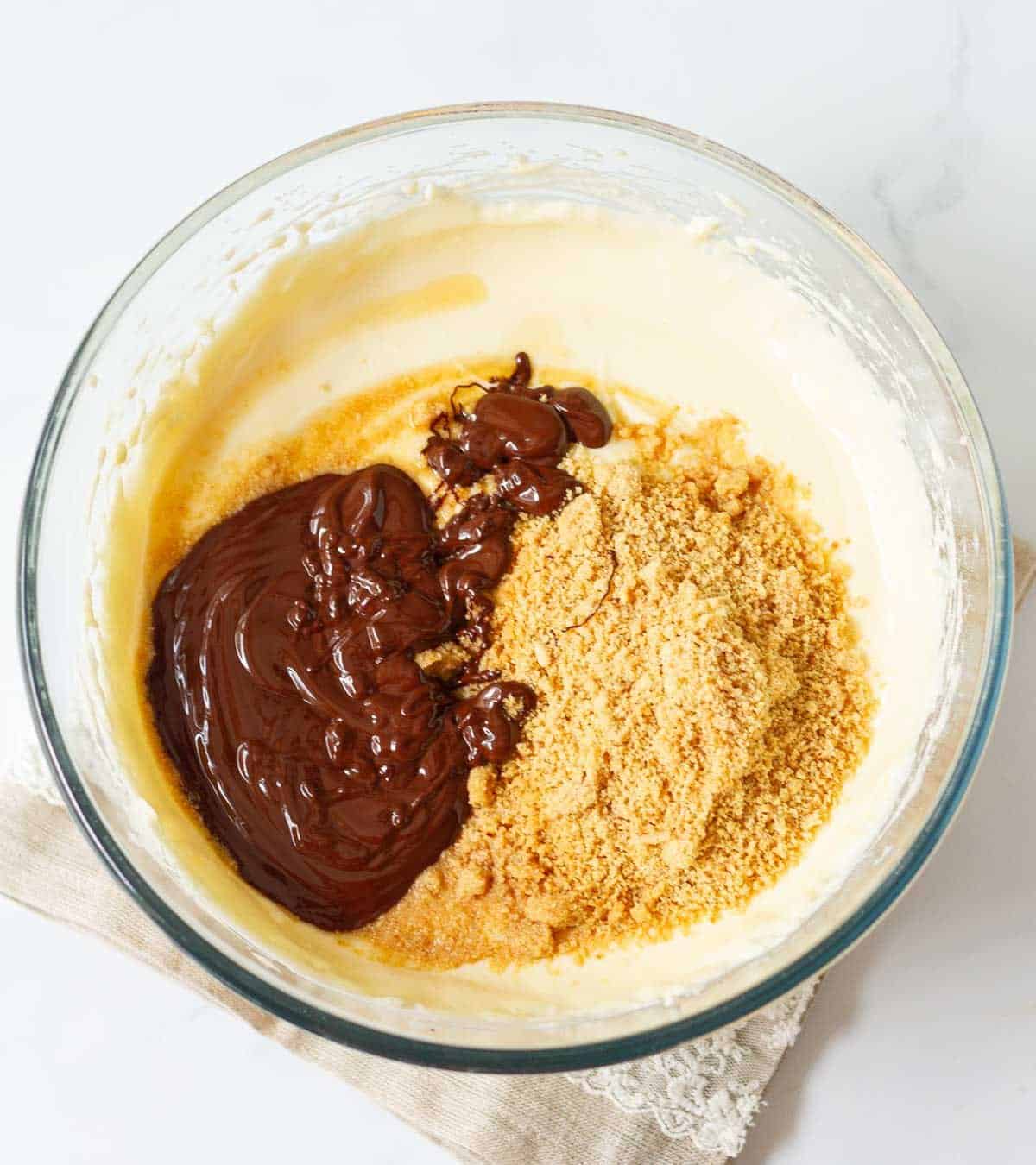 Melted chocolate, crushed hazelnuts on top of cream cheese mixture.