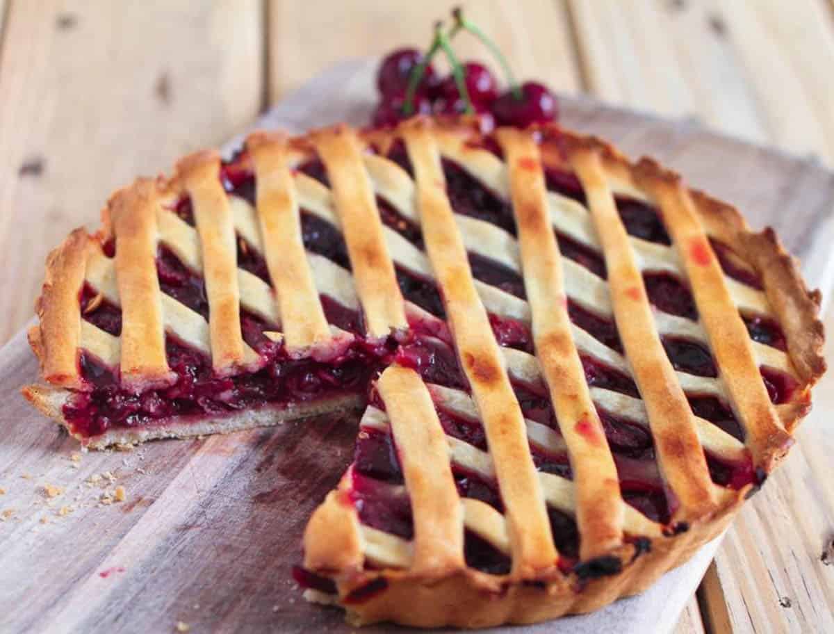 Cherry pie with a slice cut to show the filling.