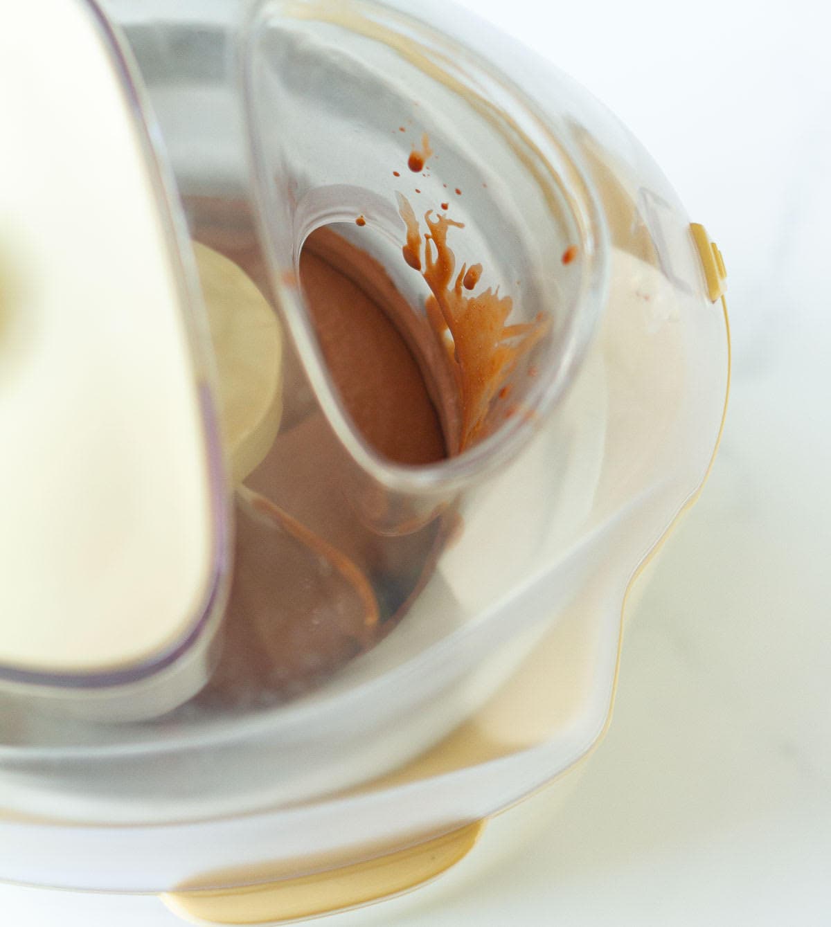 Chocolate ice cream getting churned in an ice cream maker.