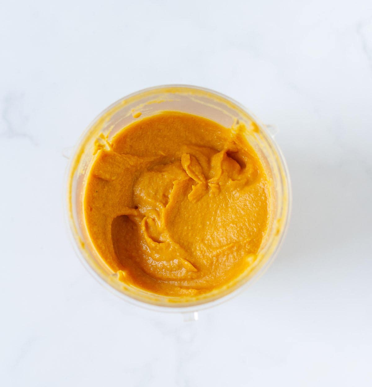 Blended hummus mixture in a blender jar.