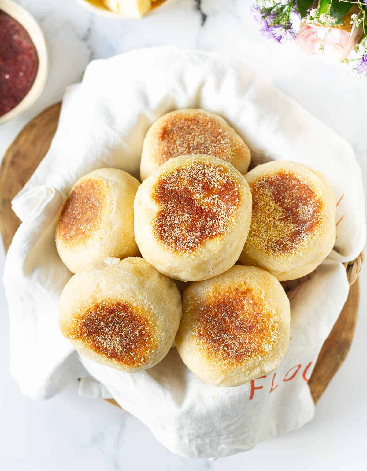 SImple English muffins in a napkin lined basket.