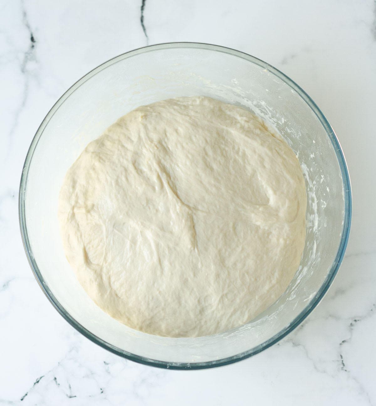 Proofed dough in a bowl.