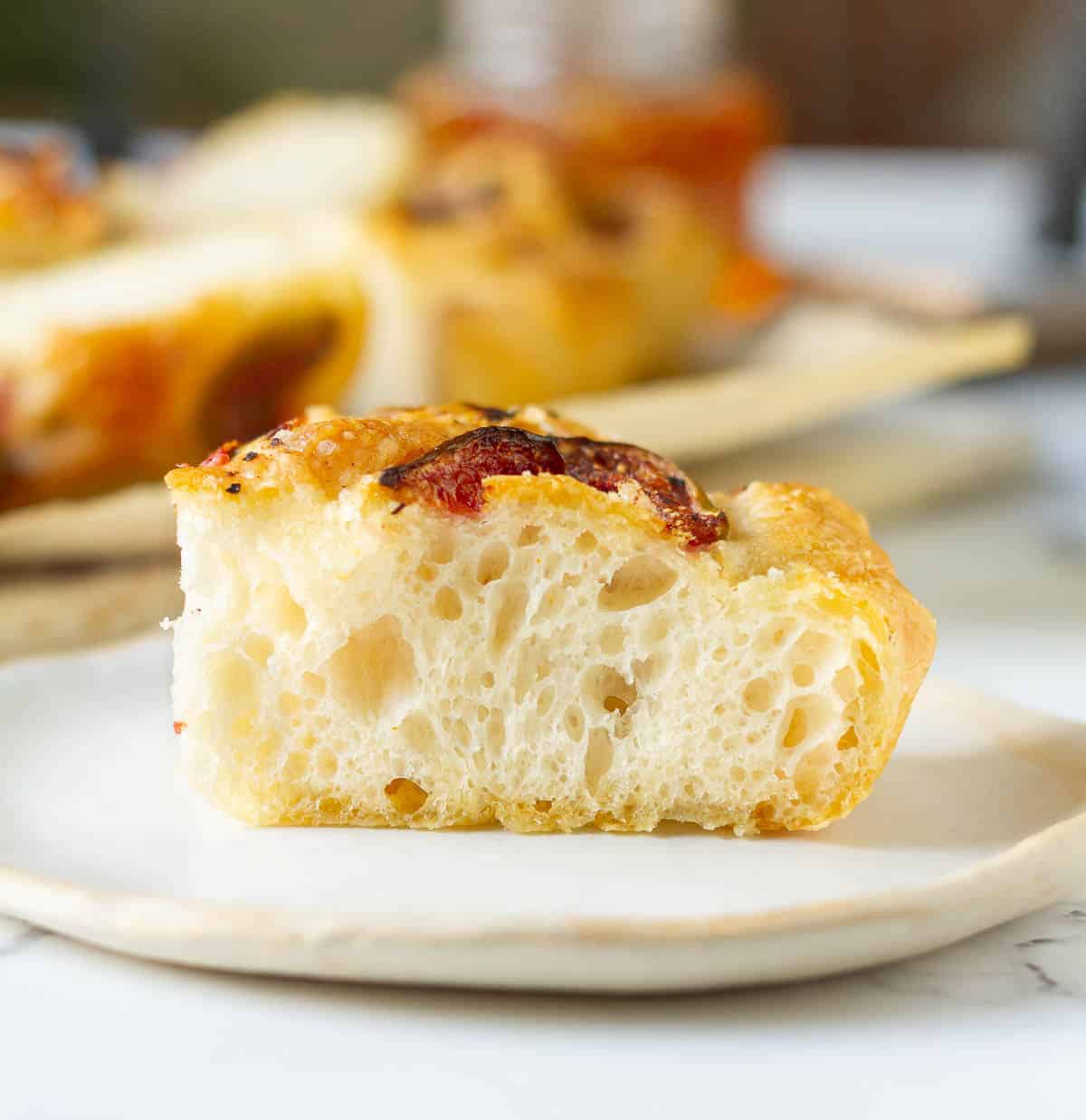 A slice of focaccia on a plate.