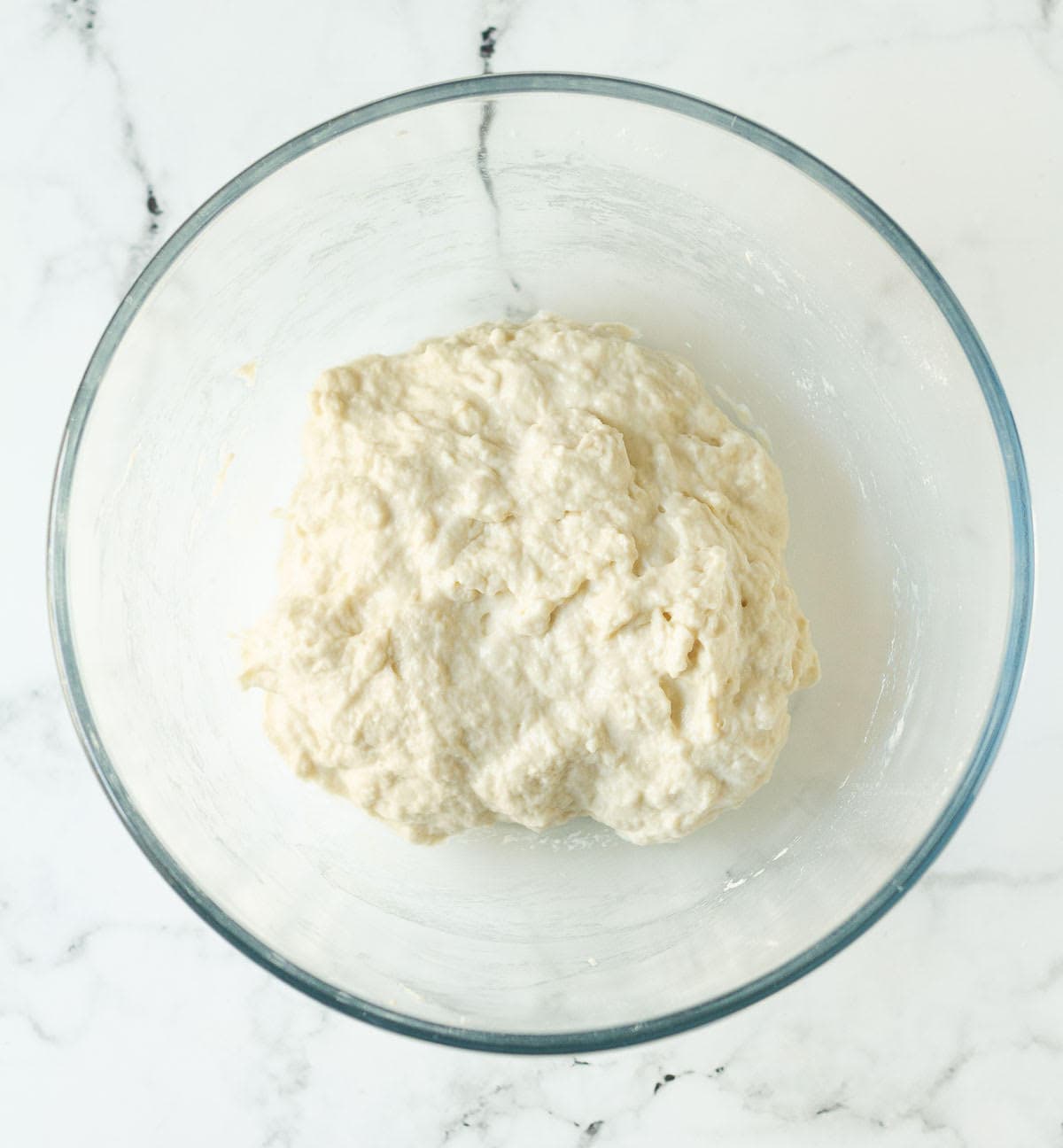 Bread dough in a mixing bowl.
