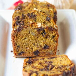 Sliced pumpkin banana bread on a white platter.