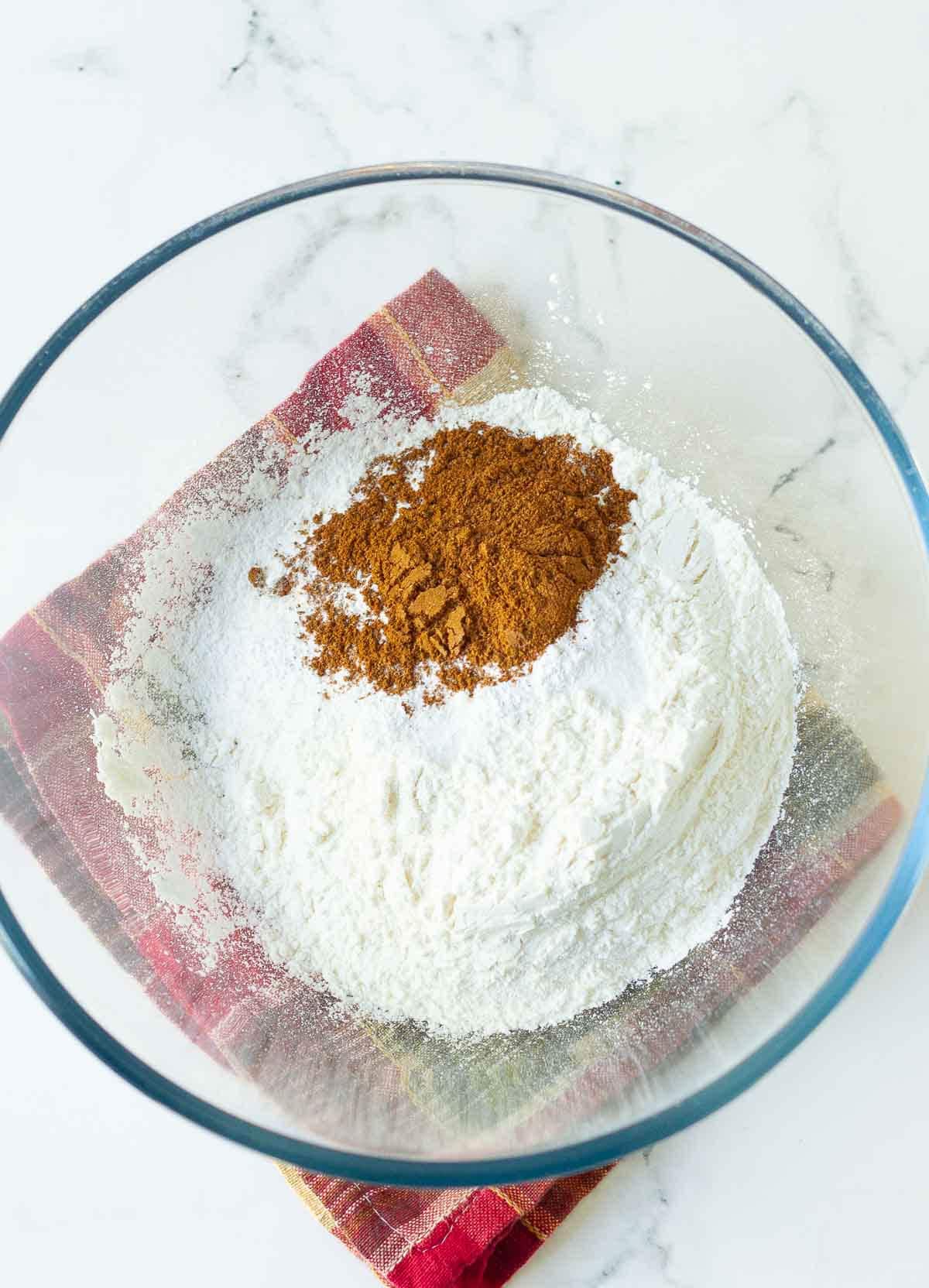 Dry ingredients for making pumpkin banana bread in a mixing bowl.