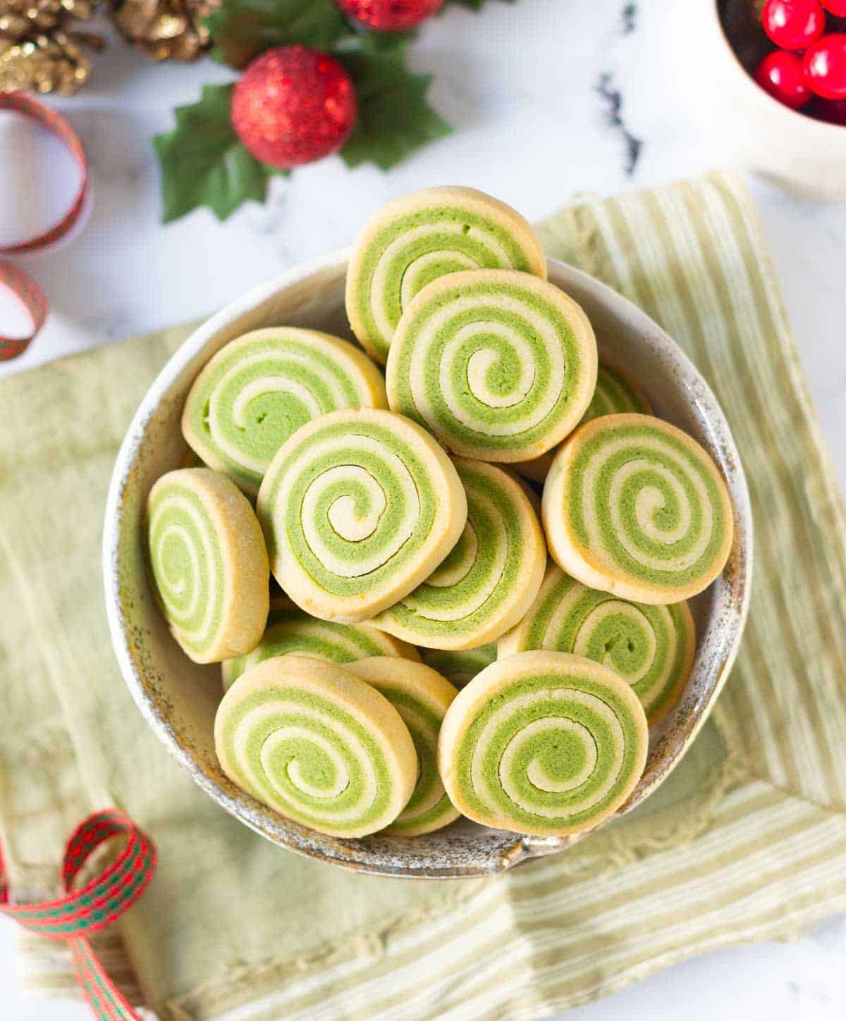 bowl of green spiral pinwheel cookies.