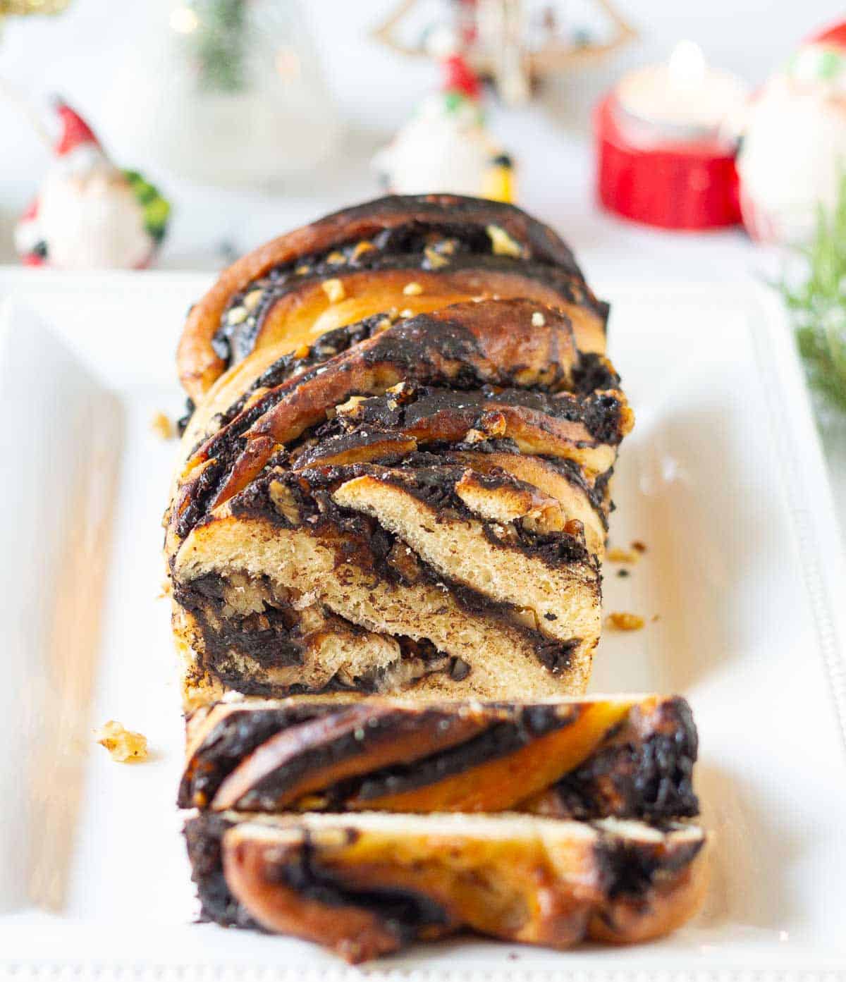 sliced babka on a white serving platter.