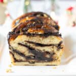 sliced chocolate babka on a platter to show the swirls in the bread.