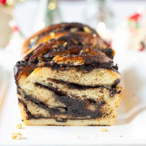 sliced chocolate babka on a platter to show the swirls in the bread.