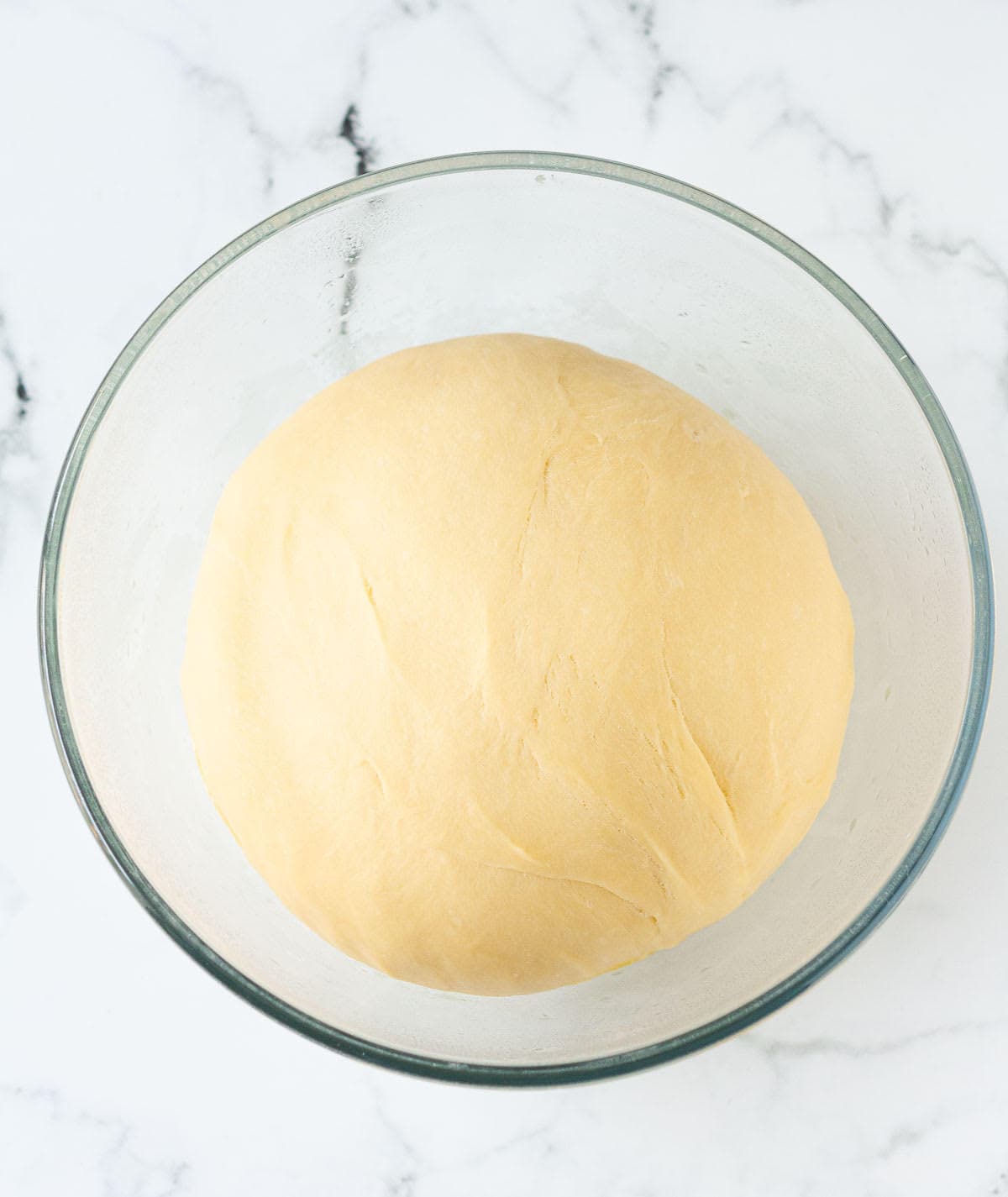 Proofed babka dough in a mixing bowl.