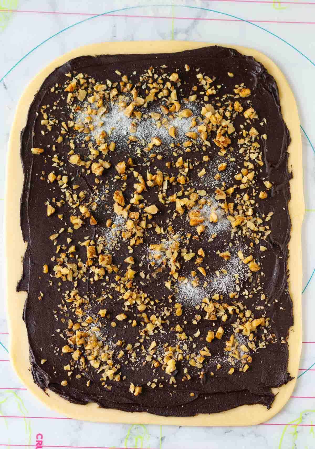 chocolate filling, walnuts and sugar spread on top of the rolled out dough.