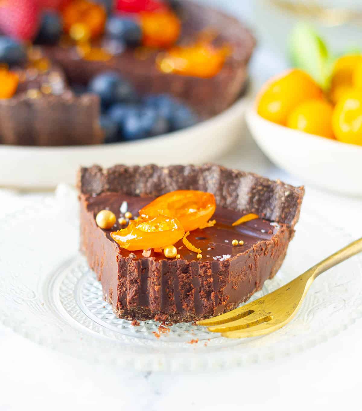 a slice of tart on a small plate with a bite taken with a fork .