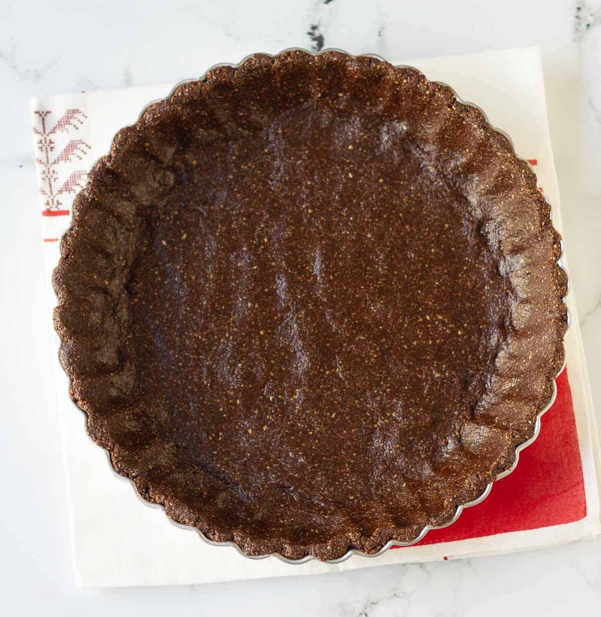 evenly press crust mixture into the bottom and sides of a tart pan.