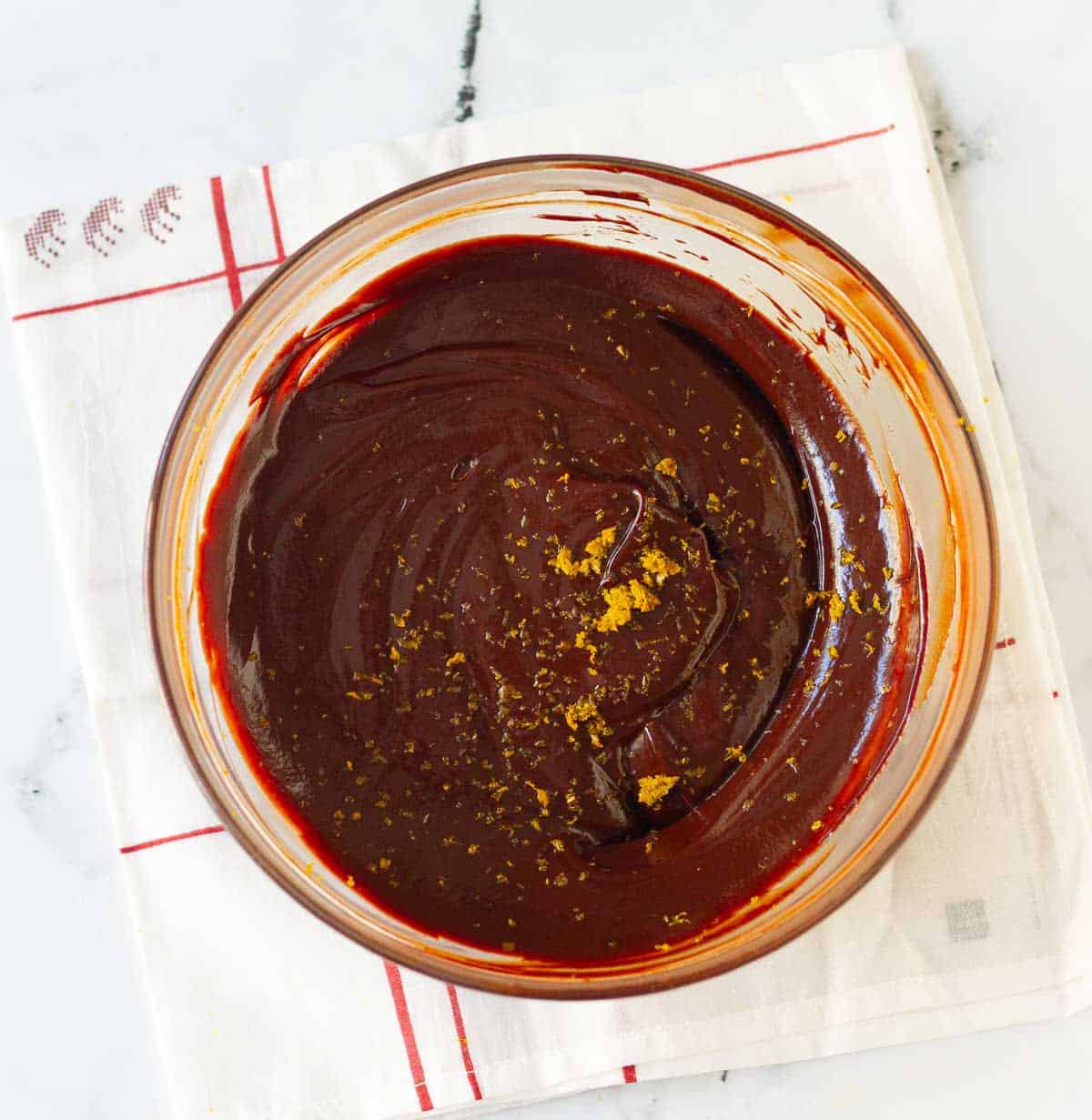 chocolate filling with orange zest in a glass mixing bowl.